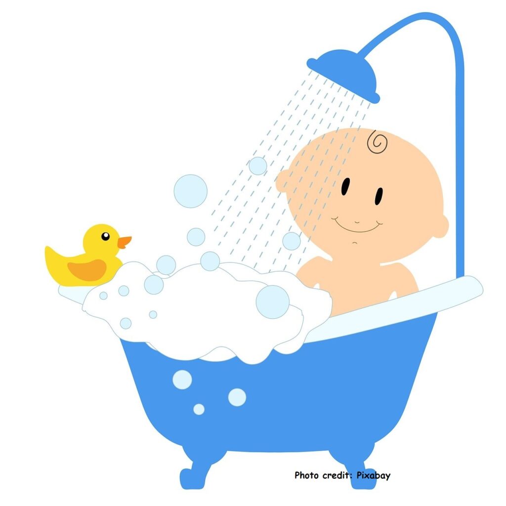 Baby in a bath under a water shower to highlight gift ideas for newborns